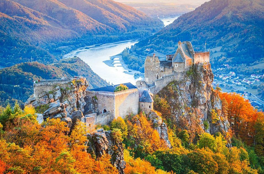 Ruined castle on a crag above the Danube in autumn colour